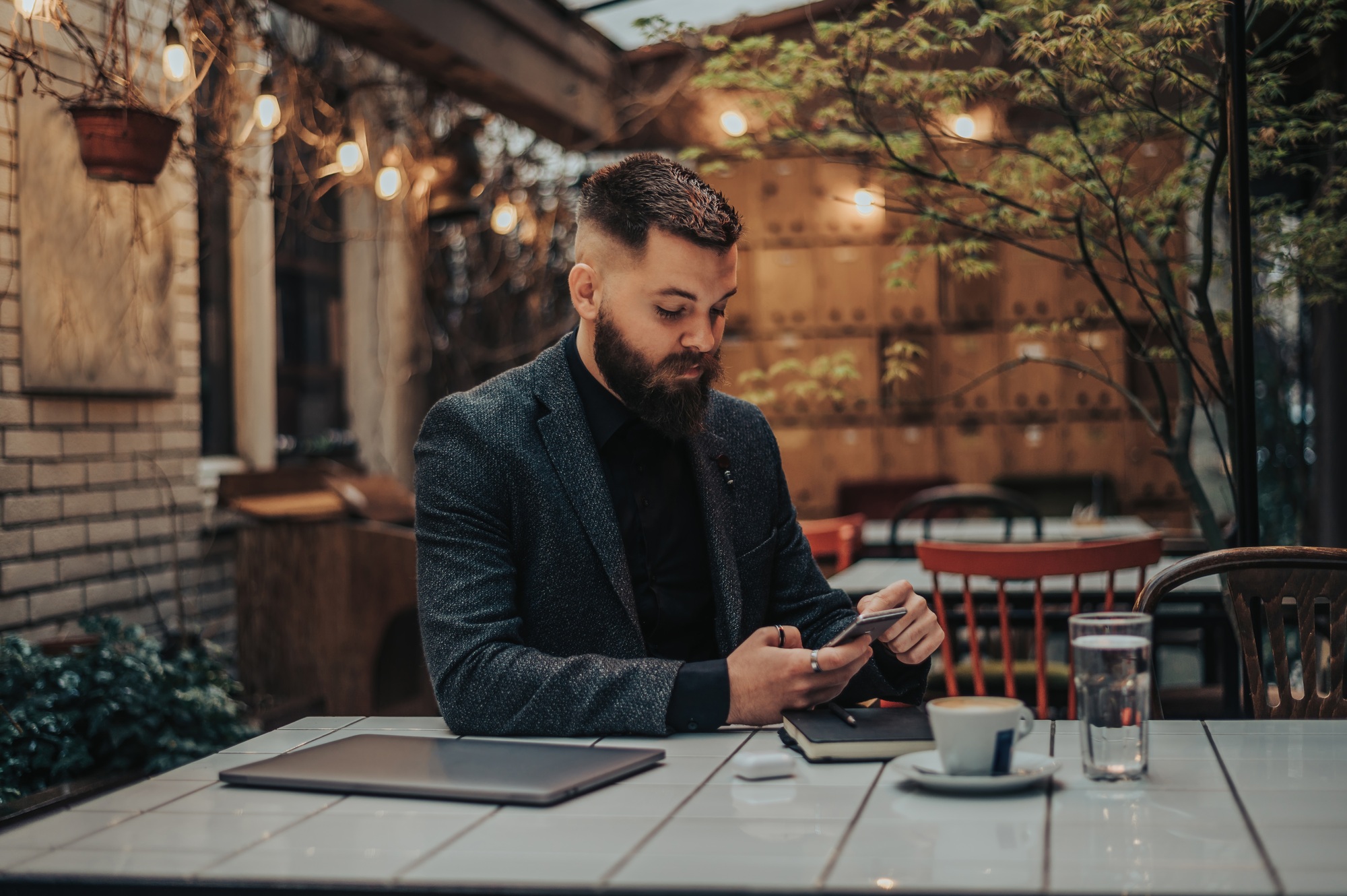 Businessman using smartphone in a cafe